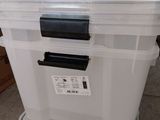 two large plastic boxes stacked on top of each other
