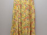 a yellow floral skirt hanging on a wall