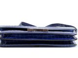 a close up of a blue purse with a gold clasp