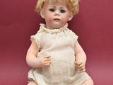 a doll that is sitting on a red surface