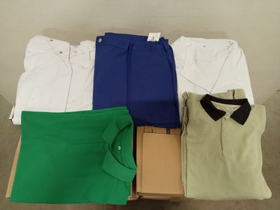 several men ' s shirts and pants are laid out on a table