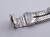 a silver bracelet that has a clasp on it
