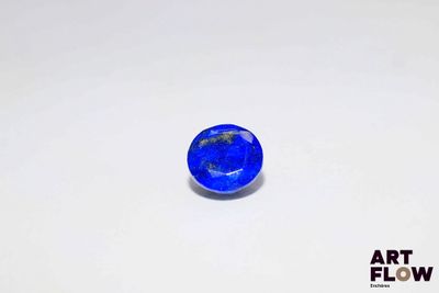 a close up of a blue stone on a white surface