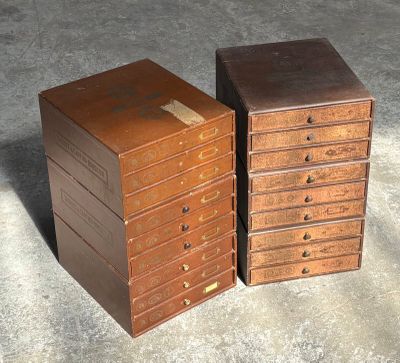 two small wooden drawers sitting next to each other on the floor