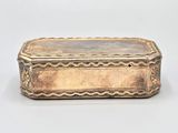 an antique silver plated box with a decorative design on the lid