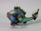 brightly colored fish figurine on a white surface with a white background