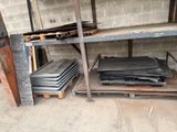 many pieces of metal sitting on a shelf in a room