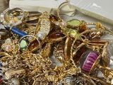 a pile of gold and silver jewelry sitting on a table