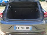 the back of a car with its trunk open in a field