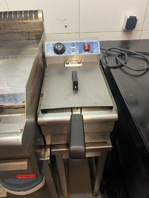 two deep fryers sitting next to each other in a kitchen