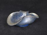 a silver and blue shell shaped object on a black surface