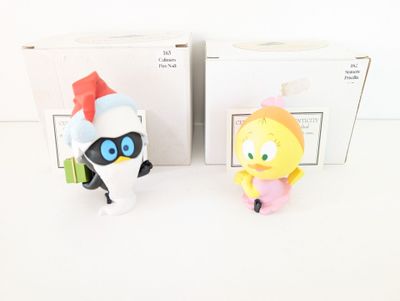 two figurines of cartoon characters in a box