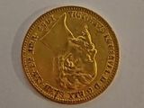 a close up of a gold coin on a white surface