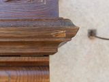 a close up of a clock on a wooden shelf