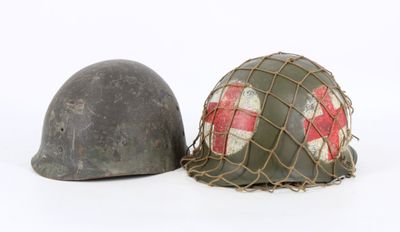 two helmets are sitting next to each other on a white surface