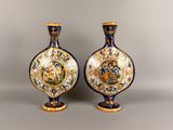 pair of blue and white vases with gold decoration on them