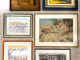 many framed pictures hanging on the wall of a room
