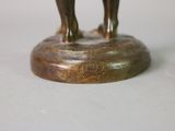 a bronze statue of two elephants standing on a base