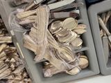 many silver spoons and forks in the trays