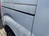 a white van parked in a parking lot next to a building