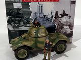a toy soldier standing in front of a toy tank