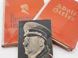 two books with a picture of a man in a military uniform and a book with a picture of a man in a military uniform and a book with a picture of