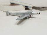a small toy airplane sitting on a table next to a box