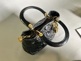 a small black purse with a gold chain on it