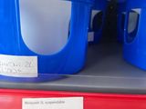 several plastic containers are stacked on a shelf in a store