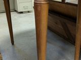 a wooden table with a red dot on the top