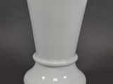 a white vase that is sitting on a table