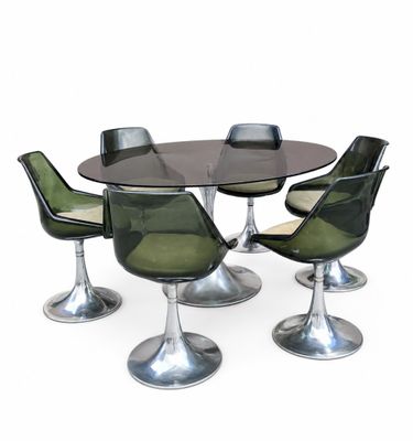 an image of a dining table with four chairs and a glass top
