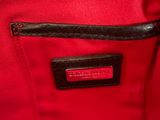 a close up of a red bag with a black handle