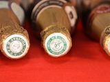 several bottles of beer are lined up on a red surface