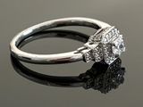 an image of a diamond ring on a reflective surface