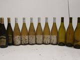 bottles of wine are lined up in a row on a counter