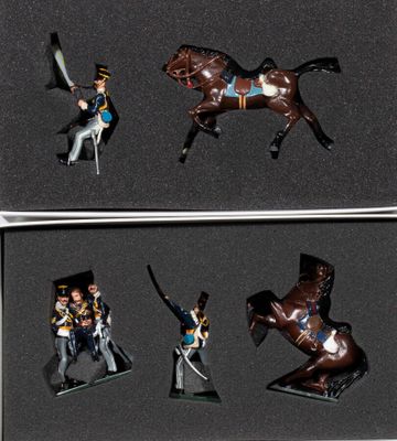 four figurines of a man on a horse in a box