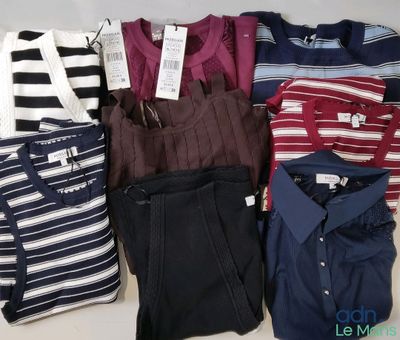 a lot of men ' s shirts and pants on the table