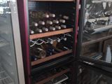 a refrigerator with many bottles of wine inside of it