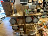 many pots and pans on the shelves in the store