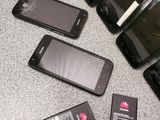 several cell phones are sitting on a table with a broken screen