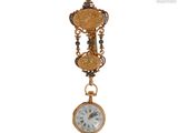 a gold clock hanging from the side of a wall