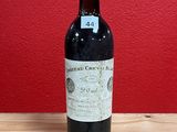 a bottle of red wine sitting on top of a wooden table