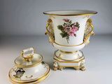 two vases with flowers on them sitting on a table