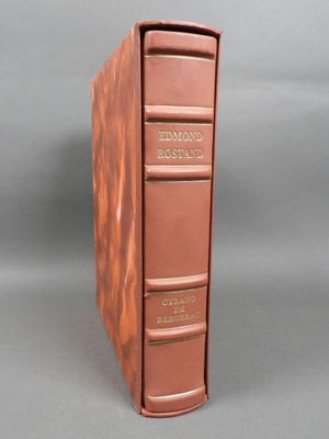 an old book with a brown cover sitting on top of a table