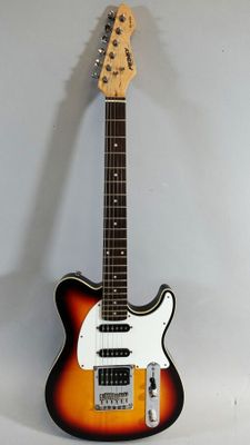 an electric guitar sitting on top of a table next to a white wall