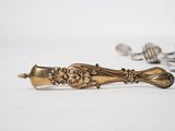a gold spoon and spoon rest on a white surface
