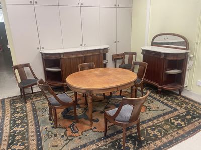 a table and chairs in a room with a rug on the floor