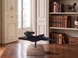 a statue of a dog on a table in a room