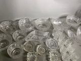 a lot of glass dishes and bowls on the table